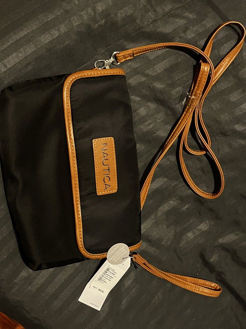 AUTHENTIC NAUTICA BAG (Category: Cross-body Bags) located in Pasig City. Submitted by malelate (Listing ID 1460213591, Image 3). Description: SELLING AN AUTHENTIC / ORIGINAL NAUTICA OVERSIZED CLUTCH CROSSBODY BAG •A black bag that can be used as a clutch or cross body bag (both has detachable attachments based on your preferred style) •Made of Nylon material •With RFID BLOCKING PROTECTION ALREADY •Tags are still intact •Bought personally in the U