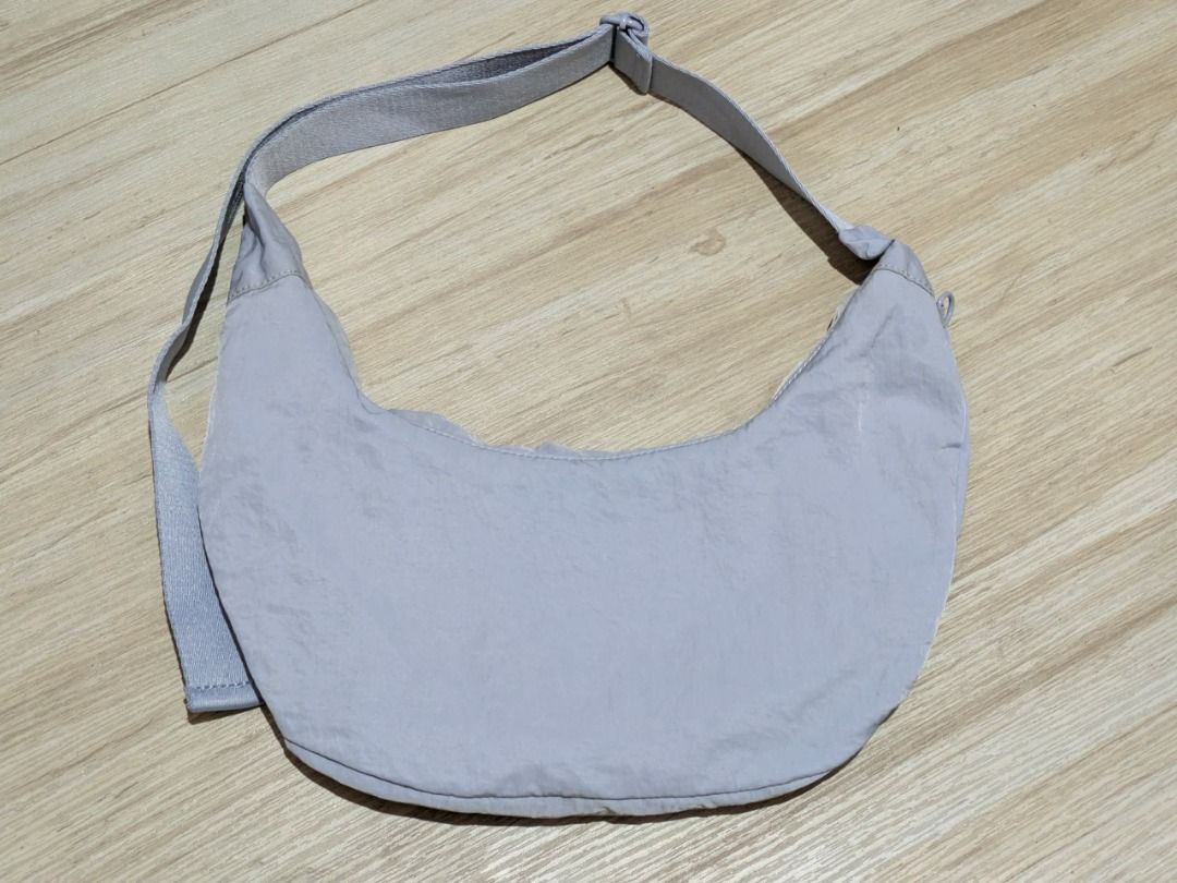 Baby Blue Nylon Crescent/Dumpling Shoulder Bag (Category: Shoulder Bags) located in Antipolo. Submitted by maxineborbon (Listing ID 1460234808, Image 1). Description: - L: 11 in / 26cm W: 14 in / 35cm - Baby Blue nylon shoulder bag - Chic crescent shape - Adjustable strap for comfort - Crinkled nylon material adds texture - Ideal for everyday wear - Versatile and easy to match with any outfit - Has slight stain on the zipper part but not very vis