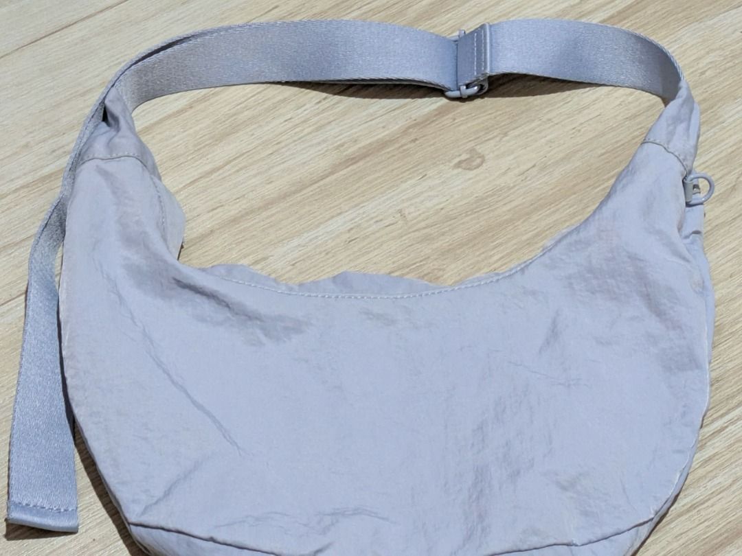 Baby Blue Nylon Crescent/Dumpling Shoulder Bag (Category: Shoulder Bags) located in Antipolo. Submitted by maxineborbon (Listing ID 1460234808, Image 2). Description: - L: 11 in / 26cm W: 14 in / 35cm - Baby Blue nylon shoulder bag - Chic crescent shape - Adjustable strap for comfort - Crinkled nylon material adds texture - Ideal for everyday wear - Versatile and easy to match with any outfit - Has slight stain on the zipper part but not very vis