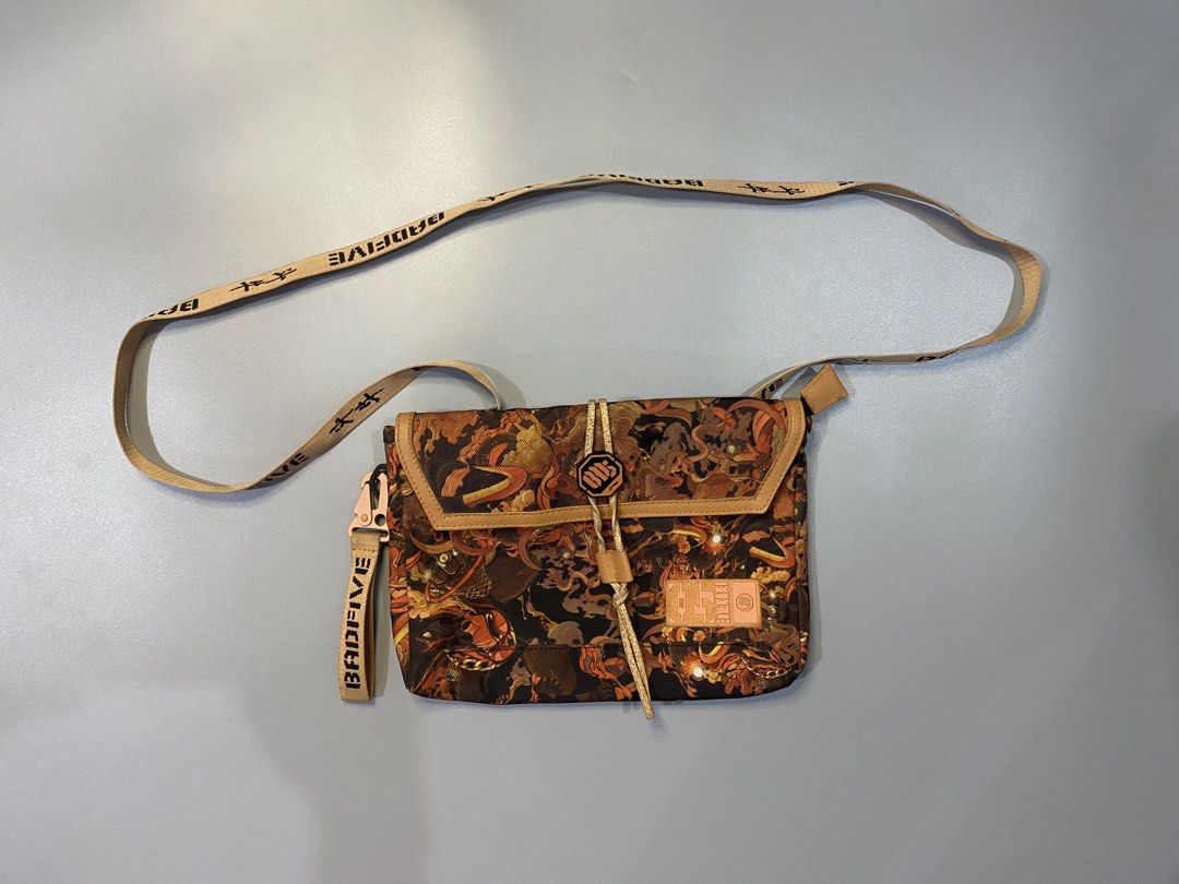 BADFIVE Crossbody Bag with Unique Pattern (Category: Cross-body Bags) located in Manila. Submitted by syke.archiveorg (Listing ID 1460141844, Image 1). Description: - Unique, eye-catching pattern - BADFIVE logo on strap - Small tag on front - Adjustable strap for comfort - Ideal for everyday use or as a statement piece.