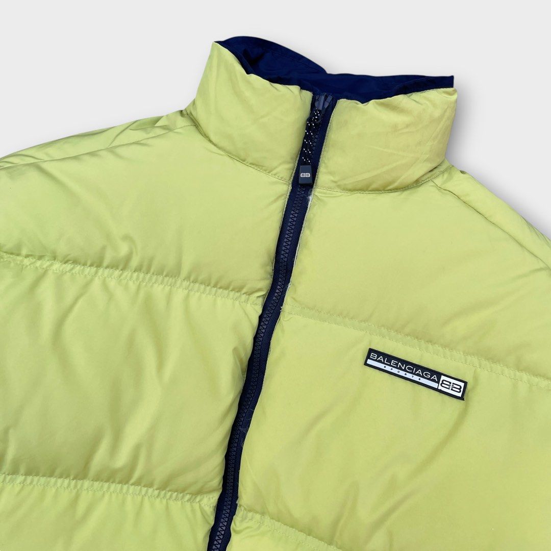 Balenciaga - Sports Reversible Down Puffer Jacket (Category: Coats, Jackets and Outerwear) located in Los Banos. Submitted by declutterking (Listing ID 1460135337, Image 3). Description: Size 3 on tag Expertly blending luxury and streetwear, this jacket offers versatile style for any occasion. With its reversible design, this jacket is perfect for both formal and casual settings. Neon green/navy colorway. Dimensions: 20.25" shoulders 25" chest 26