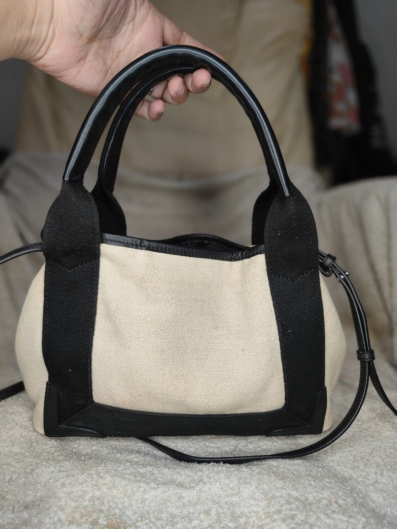 Balenciaga Canvas and Leather Mini Bag (Category: Luxury Bags & Wallets) located in Cebu City. Submitted by cherreymie70208 (Listing ID 1460266327, Image 2). Description: - 💯✅ Balenciaga Cabas XS Tote bag -Cut/missing pouch - Color: Beige canvas with black leather trim - Features: Top handles and detachable shoulder strap - Closure: Drawstring - Interior: Balenciaga branding - Size: Small and compact, ideal for essentials.
