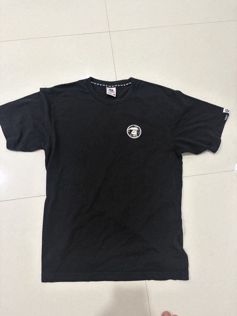 BAPE AAPE By A Bathing Ape T-shirt (Category: Tshirts & Polo Shirts ) located in Marilao. Submitted by astroman.22 (Listing ID 1460264208, Image 1). Description: - Black BAPE t-shirt - Iconic ape logo on chest - Small logo detail on sleeve - Perfect for casual outfits.