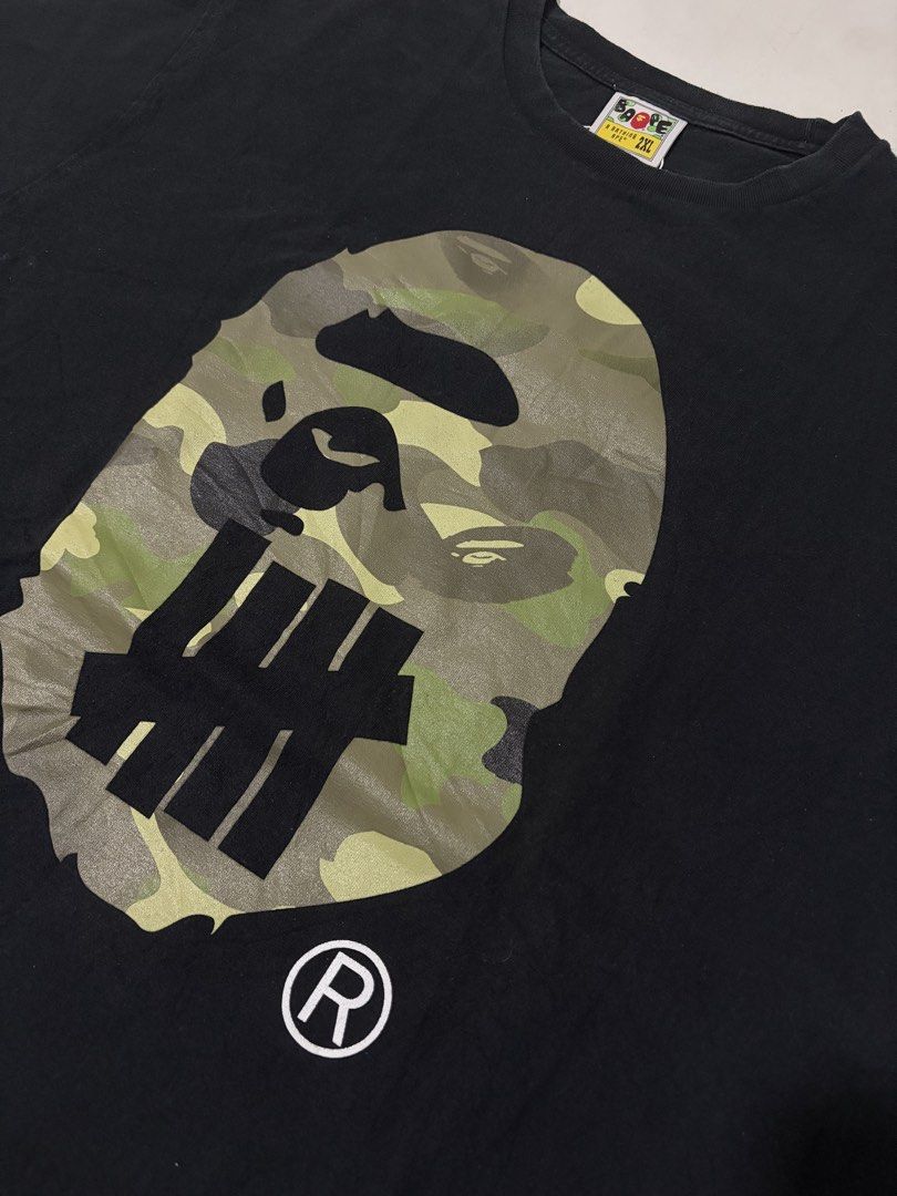 BAPE x Undefeated Camo Ape Head Tee (Category: Tshirts & Polo Shirts ) located in Manila. Submitted by swaaaaggy (Listing ID 1460198229, Image 2). Description: Bape x Undefeated Big head Size 2XL (22x30) Excellent Condition Authentic ₱3,000.