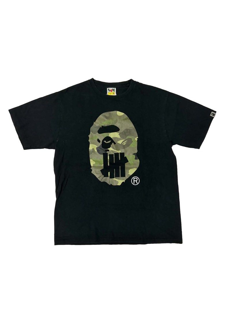 BAPE x Undefeated Camo Ape Head Tee (Category: Tshirts & Polo Shirts ) located in Manila. Submitted by swaaaaggy (Listing ID 1460198229, Image 1). Description: Bape x Undefeated Big head Size 2XL (22x30) Excellent Condition Authentic ₱3,000.