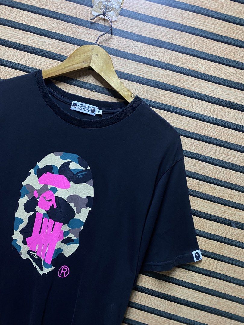 BAPE X UNDEFEATED TEE (Category: Tshirts & Polo Shirts ) located in Makati City. Submitted by drip.poww (Listing ID 1460275174, Image 3). Description: - Bape x Undftd - Color: Black - Size: Large - Dimes: 23x31 - Authentic - Excellent condition - Need wash, fresh from bale - Issue: Last pic - Material: 100% Cotton Please don’t expect too much—these are thrifted (ukay) items. 😊 !!STILL NEGOTIABLE!!.