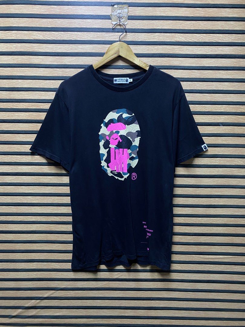 BAPE X UNDEFEATED TEE (Category: Tshirts & Polo Shirts ) located in Makati City. Submitted by drip.poww (Listing ID 1460275174, Image 1). Description: - Bape x Undftd - Color: Black - Size: Large - Dimes: 23x31 - Authentic - Excellent condition - Need wash, fresh from bale - Issue: Last pic - Material: 100% Cotton Please don’t expect too much—these are thrifted (ukay) items. 😊 !!STILL NEGOTIABLE!!.