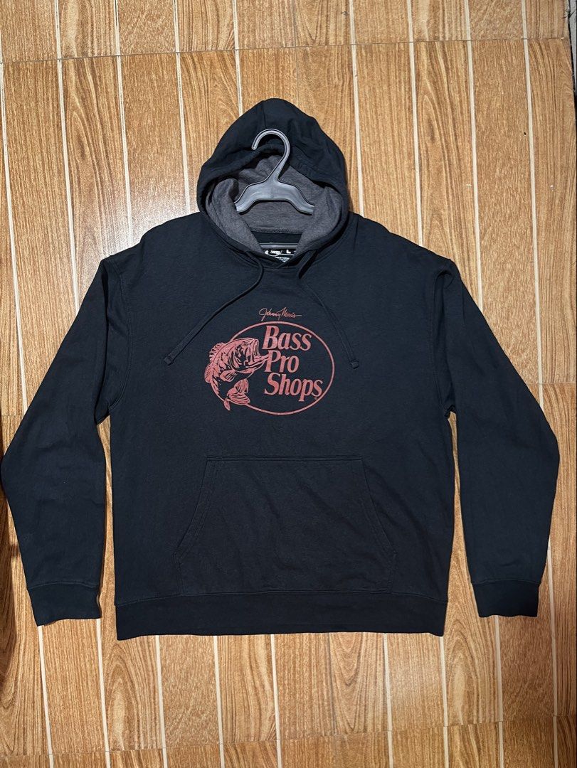 Bass Pro Shops pullover hoodie (Category: Hoodies) located in Lucena. Submitted by mjaothrift (Listing ID 1460299809, Image 1). Description: Bass Pro Shops pullover hoodie featuring a red fish logo and the Johnny Morris signature detail on the chest Size large on tag 24 x 27 inches .
