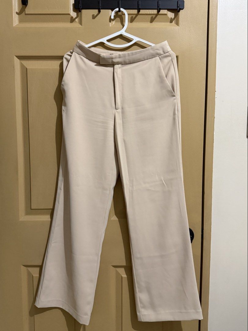 Beige Wide Leg Trousers (Category: Other Bottoms) located in Manila. Submitted by chavirly (Listing ID 1460189277, Image 1). Description: - Beige wide leg trousers - High waisted fit - Two side pockets and one back pocket - Button and zip closure - Versatile for work or casual wear - Made with comfortable fabric.
