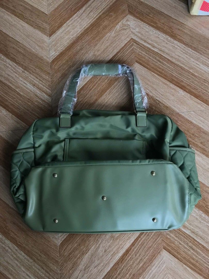 Bella Russo Quilted Duffle Bag - Olive Green (Category: Luxury Bags & Wallets) located in Quezon City. Submitted by davidmelvin28 (Listing ID 1460170555, Image 2). Description: - Olive green quilted duffle bag from Bella Russo - Zippered front pocket and side pockets - Detachable shoulder strap included - Protective studs on the bottom - Comes with a dust bag - Ideal for travel or gym use.