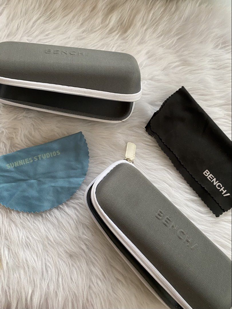 Bench Eyeglass Cases with Cleaning Cloths (Category: Sunglasses & Eyewear) located in Batangas. Submitted by v.ukay (Listing ID 1460163685, Image 1). Description: PAMIGAY LANG WALANG KAILANGANG BILHIN just pay for the sf rfs: decluttering check my account for more free listings! please help a girl declutter 😫 - Two grey Bench eyeglass cases with white trim and zippers. - One case includes a Bench cleaning cloth. - The other case includes a Sunni