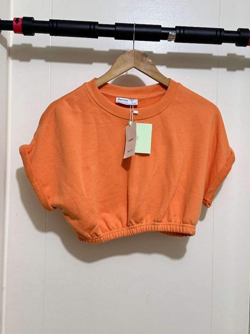 Bershka Orange Cropped Sweatshirt (Category: Longsleeves) located in Mandaluyong City. Submitted by lovedbyjaaaam (Listing ID 1460272383, Image 1). Description: - Bershka orange cropped sweatshirt - Elasticated hem - Short sleeves with rolled cuffs - Brand new with tags attached - Ideal for casual wear.
