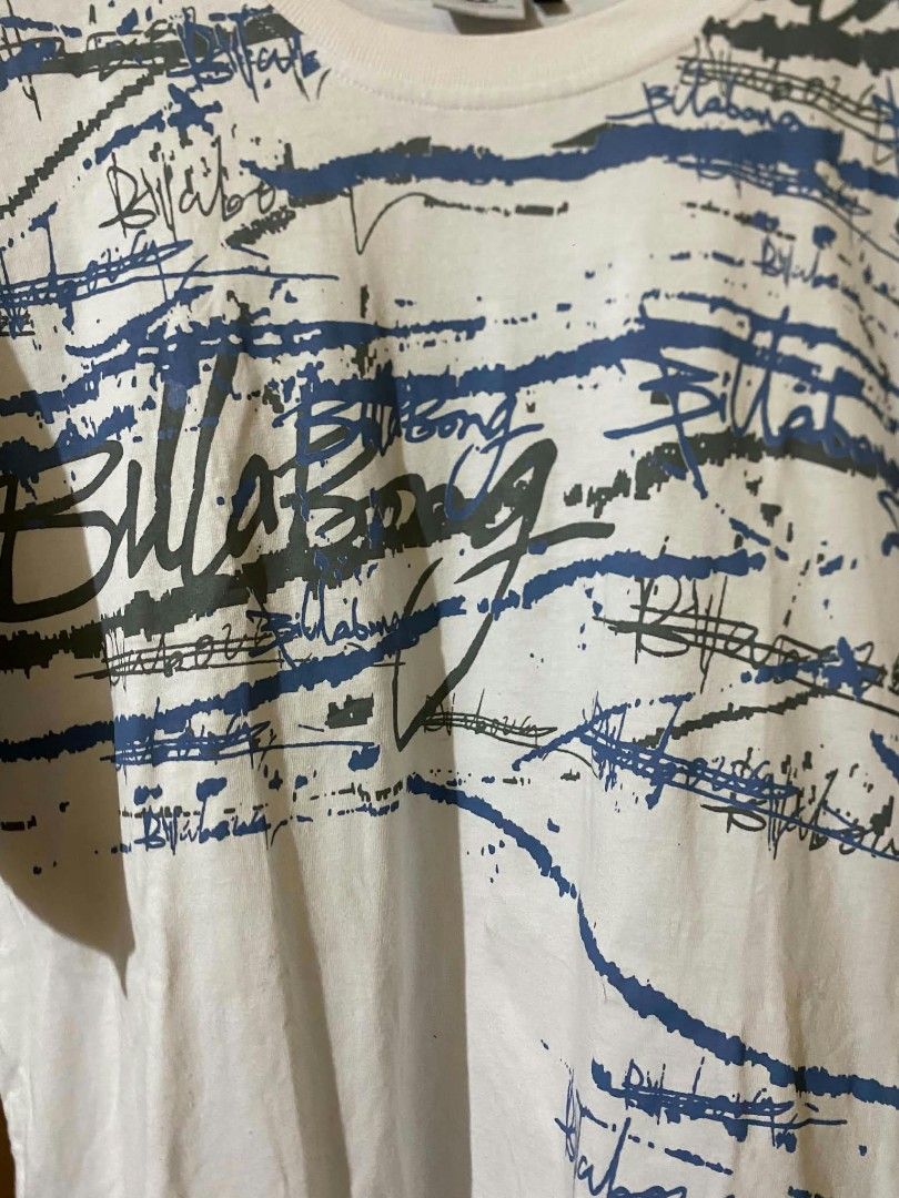Billabong White Graphic T-Shirt (Category: Tshirts & Polo Shirts ) located in Taguig. Submitted by cabugchear34421 (Listing ID 1460273887, Image 2). Description: - Vintage Billabong t-shirt - All-over graphic print - Blue and grey Billabong logo detail - No issue.