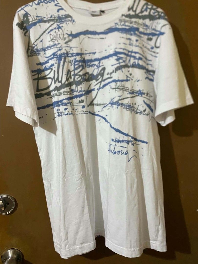 Billabong White Graphic T-Shirt (Category: Tshirts & Polo Shirts ) located in Taguig. Submitted by cabugchear34421 (Listing ID 1460273887, Image 1). Description: - Vintage Billabong t-shirt - All-over graphic print - Blue and grey Billabong logo detail - No issue.