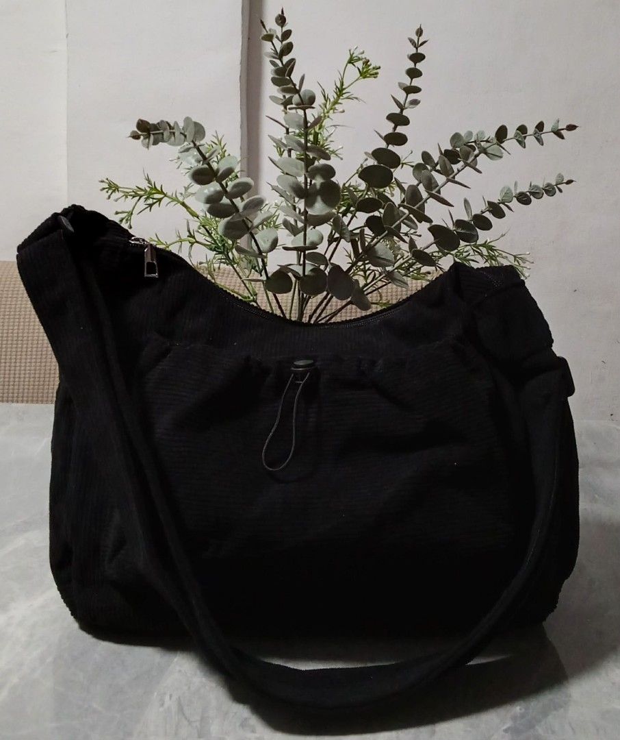 Black Corduroy Shoulder Bag with Drawstring Pocket (Category: Shoulder Bags) located in Manila. Submitted by cosmiccloud-9236 (Listing ID 1460209444, Image 2). Description: - Stylish black corduroy shoulder bag - Front drawstring pocket with zipper closure - Convenient side pockets - Adjustable strap for comfort - Ideal for everyday use - Easily fits all your essentials.