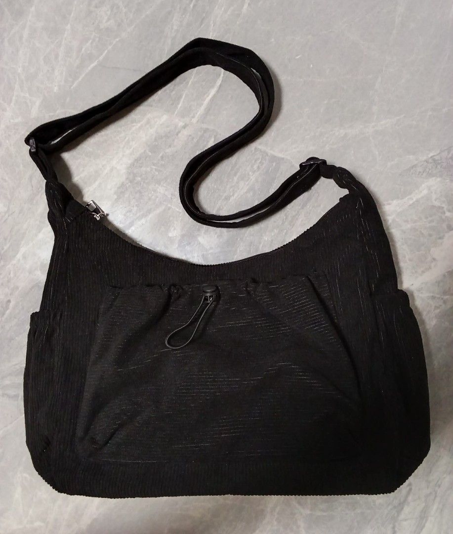 Black Corduroy Shoulder Bag with Drawstring Pocket (Category: Shoulder Bags) located in Manila. Submitted by cosmiccloud-9236 (Listing ID 1460209444, Image 1). Description: - Stylish black corduroy shoulder bag - Front drawstring pocket with zipper closure - Convenient side pockets - Adjustable strap for comfort - Ideal for everyday use - Easily fits all your essentials.
