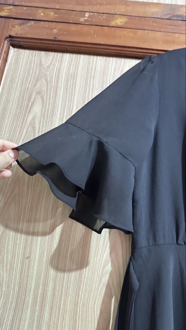 Black Flutter Sleeve Wrap Midi Dress (Category: Dresses) located in Quezon City. Submitted by cat_0820 (Listing ID 1460262322, Image 2). Description: - Chic black midi dress - Flattering flutter sleeves - Adjustable wrap style with tie belt - Lightweight and flowy fabric - Versatile for casual or dressy events - Easy to style up or down.