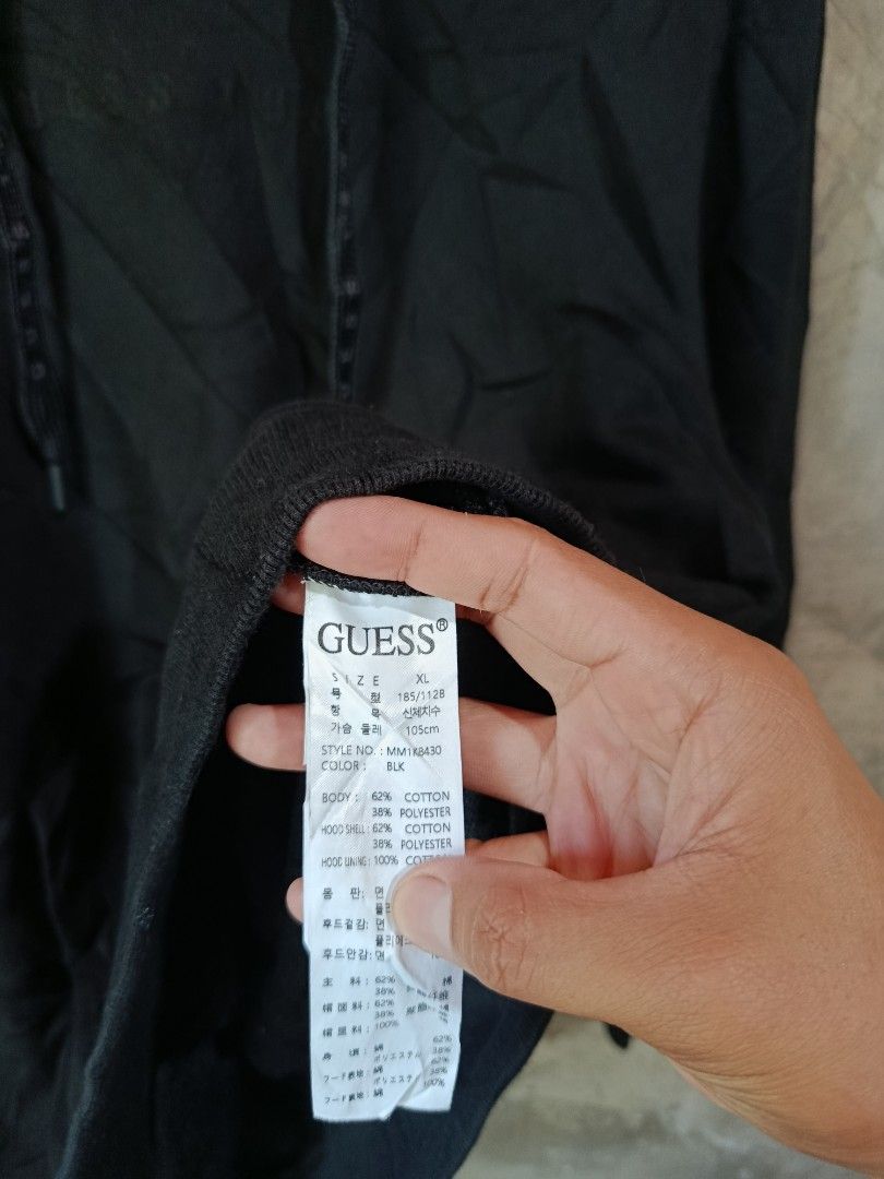 Black Guess Hoodie XL (Category: Hoodies) located in Kalamansig. Submitted by skone1996 (Listing ID 1460249134, Image 3). Description: - Guess Hoodie - Size: XL - 23 Width - 28 Length - 10/10 Color rate - No issue - Color: Black - Material: Cotton-Polyester Blend - Features: Front pocket, adjustable drawstrings - Design: Subtle embossed Guess logo on front - Ideal for: Casual wear.