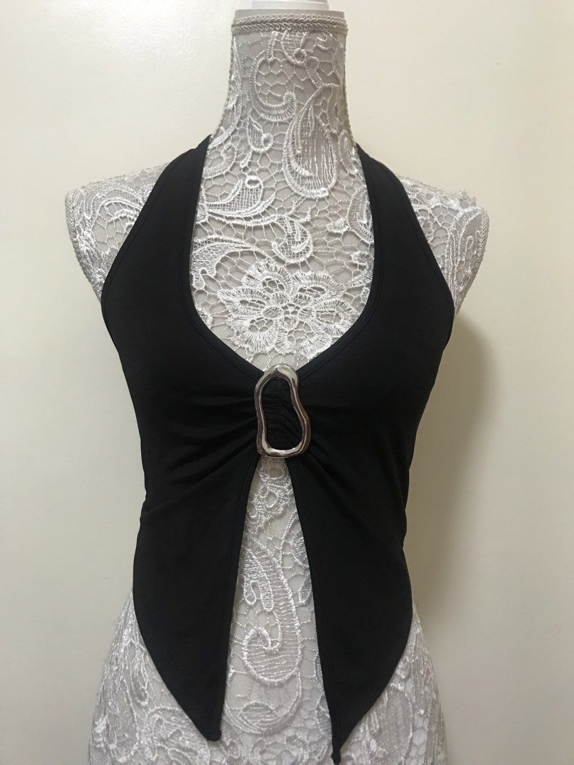 Black Halter Top with Silver Buckle Detail (Category: Sleeveless) located in Manila. Submitted by airamef28.closet (Listing ID 1460263224, Image 1). Description: - Black halter neck top - Unique front cut-out with silver metal buckle detail - Stretchy material for a comfortable fit - Simple band back - Ideal for going out or a night on the town.