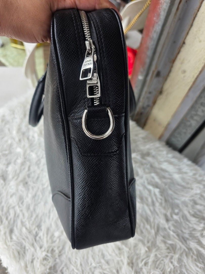Prada Black Leather Briefcase (Category: Briefcases) located in Lemery. Submitted by venus23 (Listing ID 1460106317, Image 3). Description: - Genuine black leather briefcase - Textured finish for a sophisticated look - Comfortable top handles - Secure zip closure - Stylish silver hardware details - Generous interior space for essentials - Ideal for work, meetings, or travel - Approximately 15 inches wide.