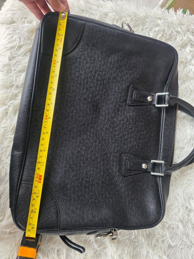 Prada Black Leather Briefcase (Category: Briefcases) located in Lemery. Submitted by venus23 (Listing ID 1460106317, Image 2). Description: - Genuine black leather briefcase - Textured finish for a sophisticated look - Comfortable top handles - Secure zip closure - Stylish silver hardware details - Generous interior space for essentials - Ideal for work, meetings, or travel - Approximately 15 inches wide.