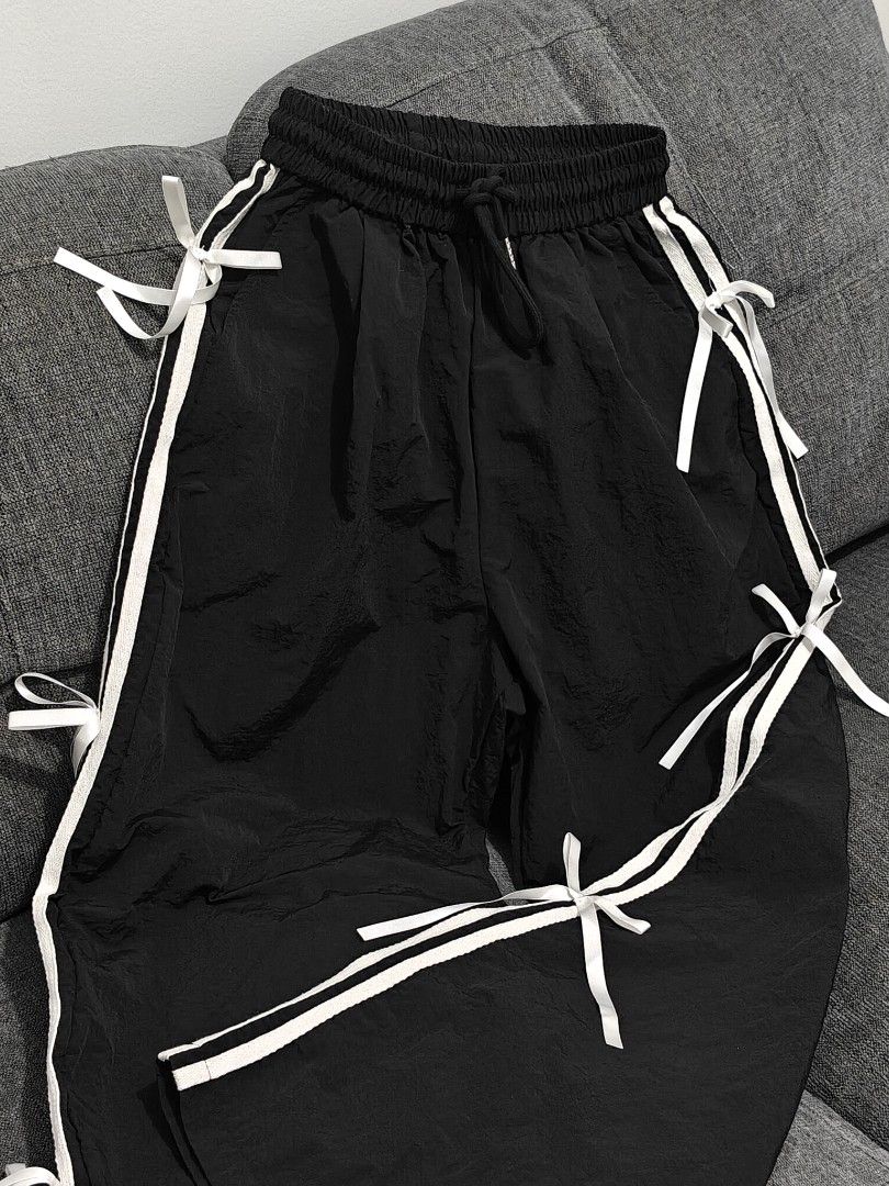 Black Track Pants / Jogging pants with bows and stripes (Category: Other Bottoms) located in Manila. Submitted by bernadeth_r (Listing ID 1460213331, Image 1). Description: Length: 38cm Fits: XS-S - Black track pants - White triple stripes down the sides with bows - Adjustable drawstring waist - Cute white bow tie details along stripes - Relaxed fit, perfect for casual wear or lounging - Easy to style up or down.