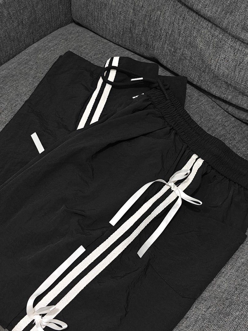 Black Track Pants / Jogging pants with bows and stripes (Category: Other Bottoms) located in Manila. Submitted by bernadeth_r (Listing ID 1460213331, Image 3). Description: Length: 38cm Fits: XS-S - Black track pants - White triple stripes down the sides with bows - Adjustable drawstring waist - Cute white bow tie details along stripes - Relaxed fit, perfect for casual wear or lounging - Easy to style up or down.