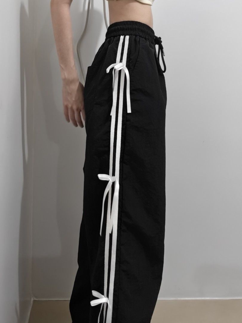 Black Track Pants / Jogging pants with bows and stripes (Category: Other Bottoms) located in Manila. Submitted by bernadeth_r (Listing ID 1460213331, Image 2). Description: Length: 38cm Fits: XS-S - Black track pants - White triple stripes down the sides with bows - Adjustable drawstring waist - Cute white bow tie details along stripes - Relaxed fit, perfect for casual wear or lounging - Easy to style up or down.