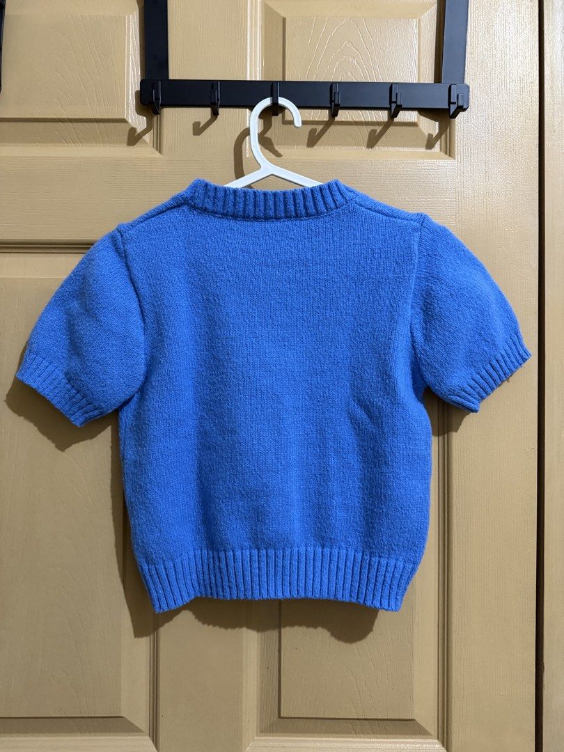 Blue Knit Short Sleeve Sweater (Category: Others Tops) located in Manila. Submitted by chavirly (Listing ID 1460189908, Image 2). Description: - Bright blue knit sweater - Short sleeves - Ribbed hem and neckline - Cozy, comfortable material - Versatile for layering or standalone wear - Simple and classic design.