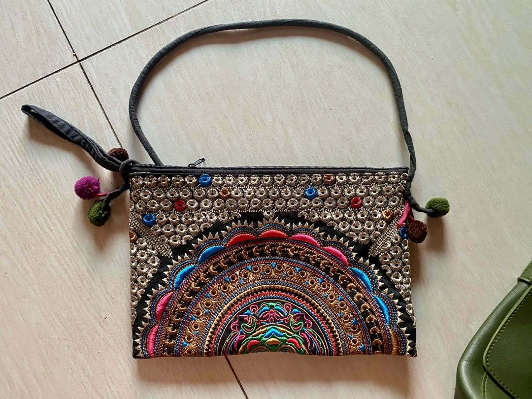 Boho Embroidered Pouch with Pom Poms (Category: Purses & Pouches) located in Zaragoza. Submitted by sherree1281 (Listing ID 1460107046, Image 1). Description: - Cute embroidered pouch with a boho vibe - Features colorful mandala-style embroidery - Adorned with small pom-pom accents - Secure zipper closure - Includes a convenient wrist strap - Ideal for organizing small essentials or as a stylish clutch.