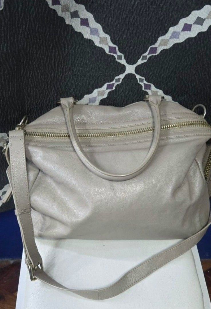 Breal Taupe Leather Bag (Category: Luxury Bags & Wallets) located in Manila. Submitted by affordabags_cd (Listing ID 1460226344, Image 2). Description: - Brand: Breal - Color: Taupe - Material: Leather - Features: Top handles, detachable shoulder strap - Exterior: Two zippered front compartments, metal studs on the bottom - Interior: Clean - Style: Great everyday bag.