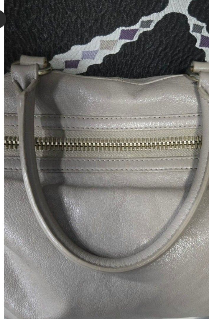 Breal Taupe Leather Bag (Category: Luxury Bags & Wallets) located in Manila. Submitted by affordabags_cd (Listing ID 1460226344, Image 3). Description: - Brand: Breal - Color: Taupe - Material: Leather - Features: Top handles, detachable shoulder strap - Exterior: Two zippered front compartments, metal studs on the bottom - Interior: Clean - Style: Great everyday bag.