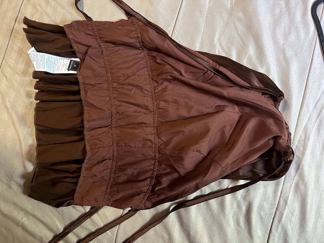 Brown Ruffled Backless Halter Party Ibiza Top (Category: Sleeveless) located in Iloilo. Submitted by shankirkpreloved (Listing ID 1460141456, Image 3). Description: Used once. When worn photo in last slide Disclaimer - Most items are preloved, so please limit your expectations. - Items will be washed, ironed, and packed properly, but it is recommended to wash them again once you recieve it. - Product color may slightly vary due to photographic li