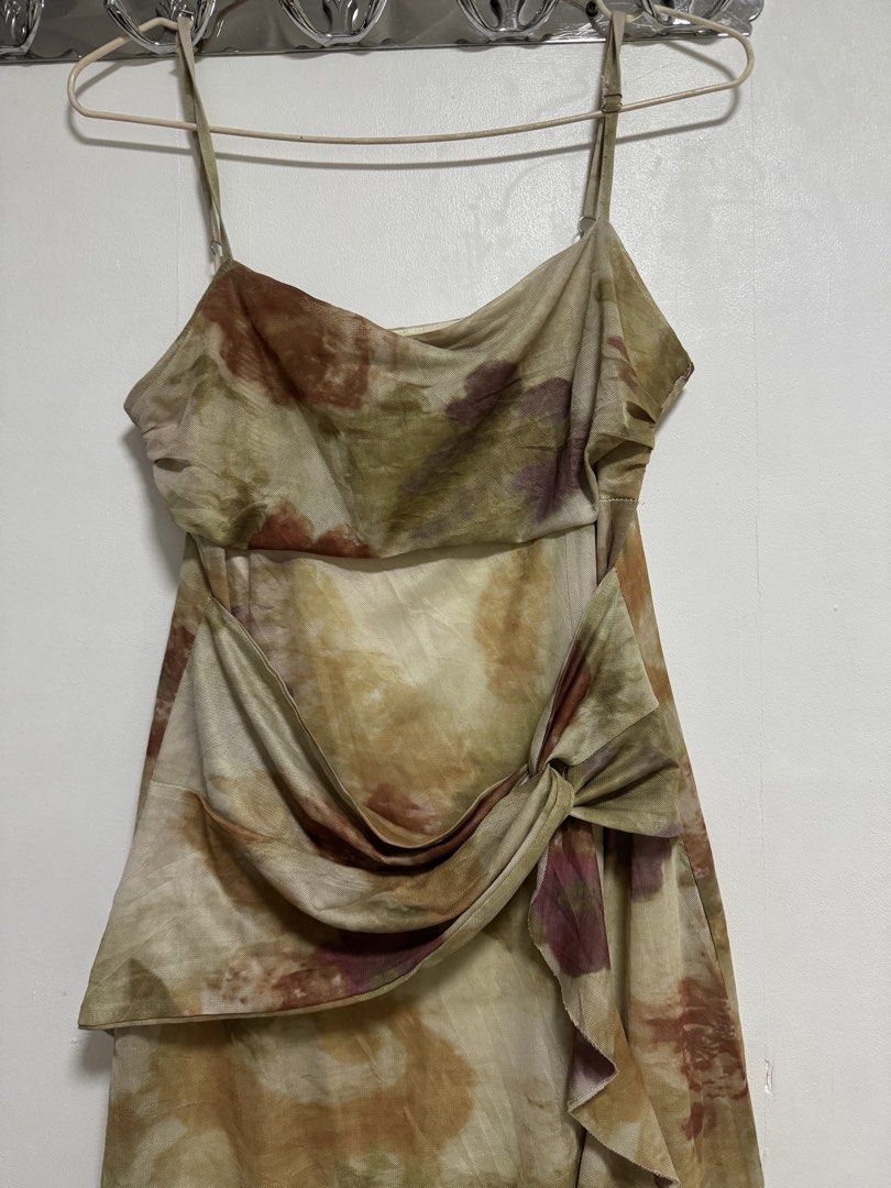 Brown Tie-Front Midi Dress Size (Category: Dresses) located in Manila. Submitted by frenchmacaron (Listing ID 1460170738, Image 2). Description: - AS Flores Fashion Collection Midi Dress - Size: Medium (M) - Unique tie-front detail - Ruffled hemline - Adjustable spaghetti straps - All-over abstract floral print in earthy tones - Versatile: suitable for casual outings or special events.