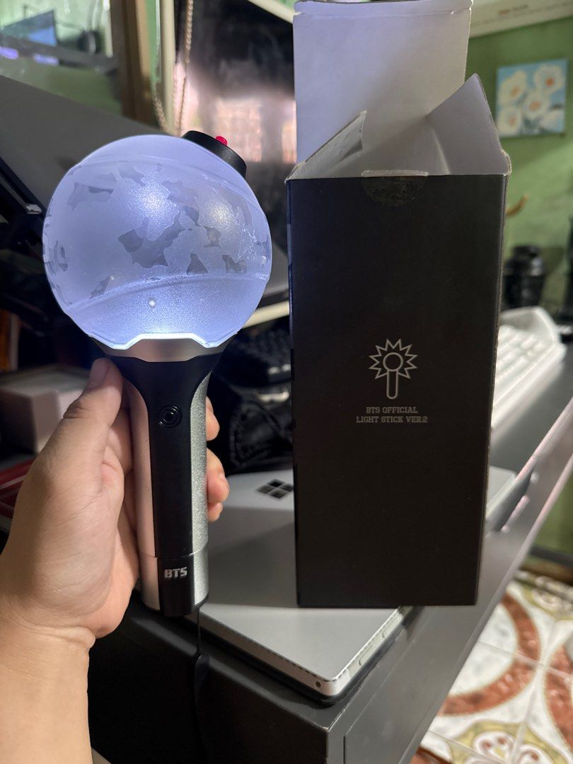 BTS Official Light Stick Ver. 2 (Army Bomb) (Category: K-Wave Merchandise) located in Lapu Lapu. Submitted by luckypenguin_01a640 (Listing ID 1460177626, Image 1). Description: Fully functional, tested. Includes official lightstick, dust bag, and original box ( note: minor tear on the top box flap, shown in photos). Inclusions: Lightstick, Dust Bag, Box..