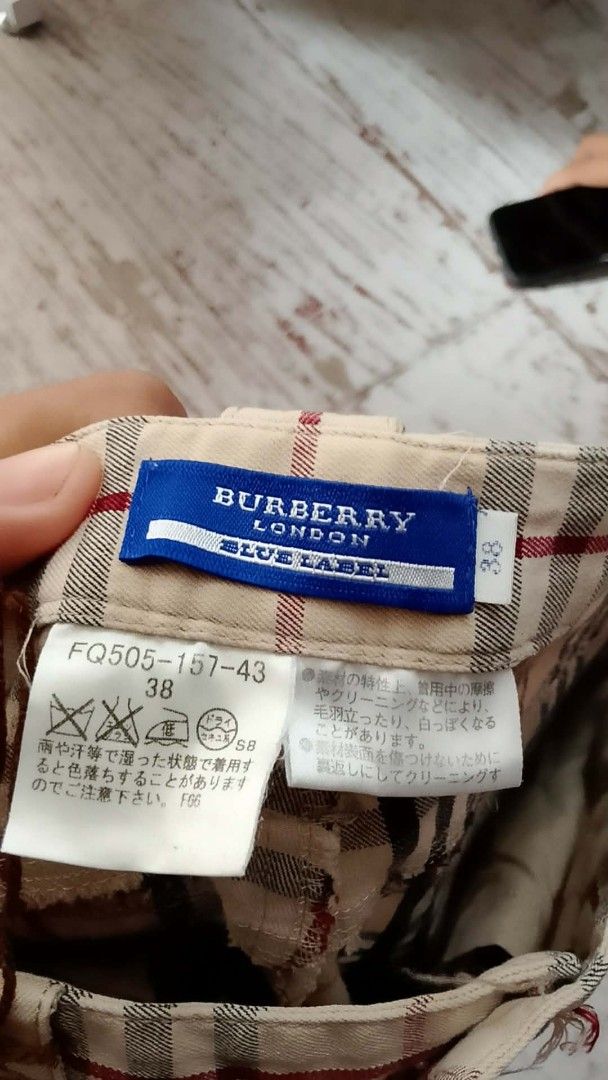 Burberry Blue Label Plaid Flare Pants (Category: Luxury Apparel) located in Iloilo. Submitted by janillthrifted (Listing ID 1460149954, Image 2). Description: - Authentic Burberry Blue Label - Classic plaid pattern on beige base - Flare leg style - Button and zip closure - Size 38 - Ideal for a stylish casual look.