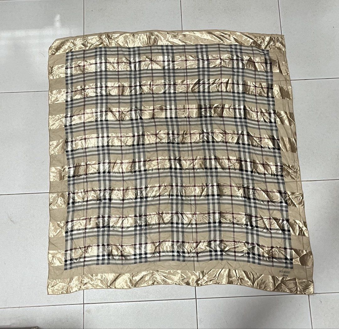 Burberry Check Silk Scarf (Category: Luxury Accessories) located in Tuguegarao City. Submitted by preowned_curation (Listing ID 1460128391, Image 3). Description: Classic plaid pattern interwoven with shimmering gold stripes. Length: 40” x Width: 37.5” Has minor dirt, needs light wash 700 + SF.