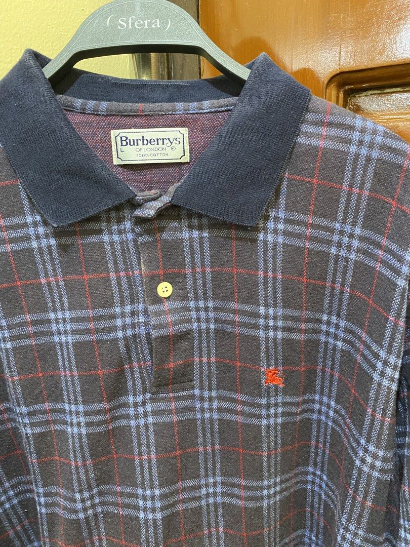 Burberrys Plaid Polo Shirt (Category: Tshirts & Polo Shirts ) located in Manila. Submitted by haveago0dthrift (Listing ID 1460155887, Image 1). Description: - Classic Burberrys of London polo shirt - Iconic plaid pattern in navy, red, and blue - Short sleeves with a button-up front - Made of 100% premium cotton - Ideal for stylish casual wear - Width 20.5 - Length 28.