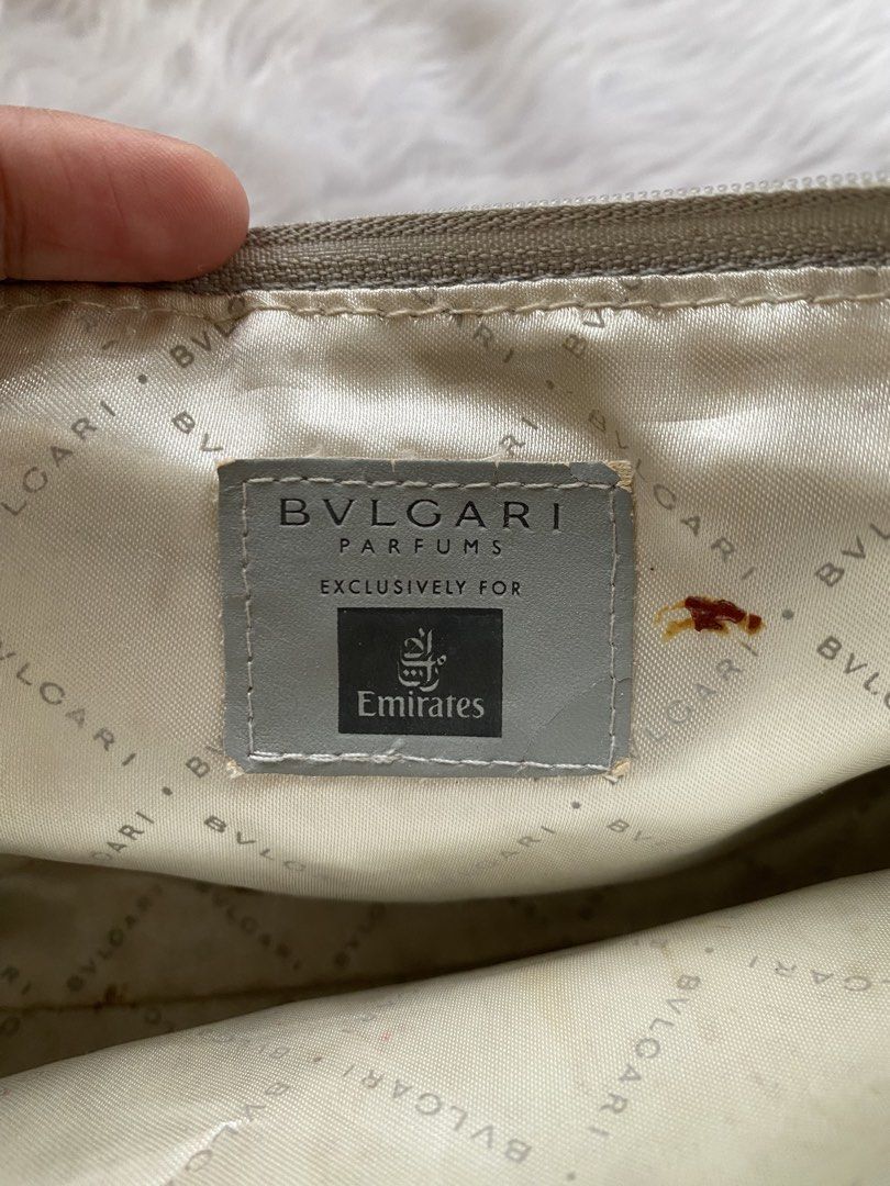 Bvlgari x Emirates Parfum Pouch Makeup Bag (Category: Purses & Pouches) located in Batangas. Submitted by v.ukay (Listing ID 1460166458, Image 3). Description: - Bvlgari Parfums grey pleated pouch - Exclusive collaboration with Emirates - Zipper closure with branded charm - Interior lining features repeating Bvlgari branding - Note: Some marks present inside the pouch - Ideal for travel or organizing small essentials.