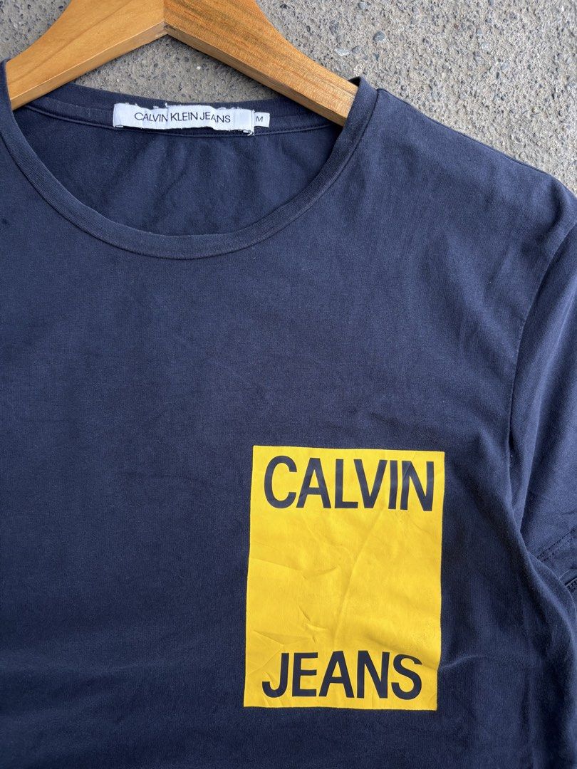 Calvin Klein Jeans Tee (Category: Tshirts & Polo Shirts ) located in Panabo. Submitted by thrifty.red (Listing ID 1460142529, Image 2). Description: 19x27 see last pic no hole loose stitch only.