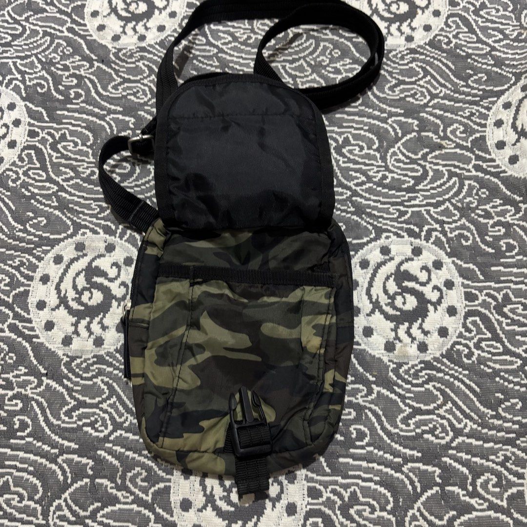 Camouflage Crossbody Bag with Adjustable Strap (Category: Cross-body Bags) located in Banga. Submitted by akosiloco (Listing ID 1460247837, Image 3). Description: - Stylish camouflage crossbody bag - Main zippered compartment for secure storage - Front flap pocket with a buckle closure for quick access - Adjustable black strap for comfortable wear - Convenient back slip pocket - Ideal for carrying essentials while on the move - Compact and practi