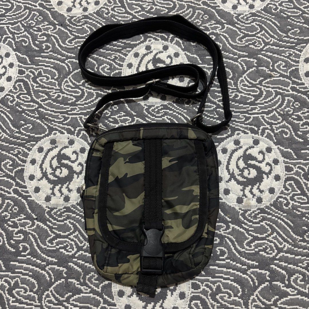 Camouflage Crossbody Bag with Adjustable Strap (Category: Cross-body Bags) located in Banga. Submitted by akosiloco (Listing ID 1460247837, Image 1). Description: - Stylish camouflage crossbody bag - Main zippered compartment for secure storage - Front flap pocket with a buckle closure for quick access - Adjustable black strap for comfortable wear - Convenient back slip pocket - Ideal for carrying essentials while on the move - Compact and practi
