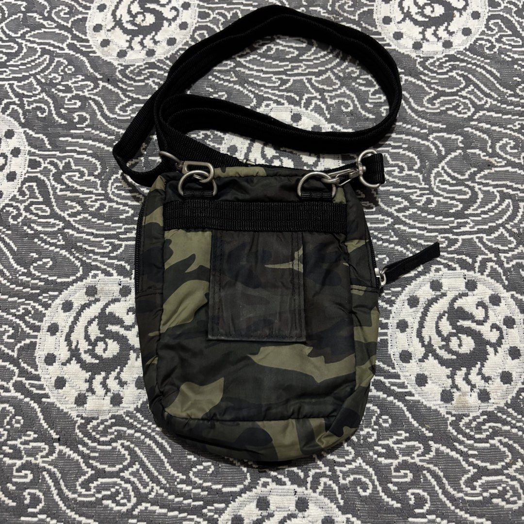 Camouflage Crossbody Bag with Adjustable Strap (Category: Cross-body Bags) located in Banga. Submitted by akosiloco (Listing ID 1460247837, Image 2). Description: - Stylish camouflage crossbody bag - Main zippered compartment for secure storage - Front flap pocket with a buckle closure for quick access - Adjustable black strap for comfortable wear - Convenient back slip pocket - Ideal for carrying essentials while on the move - Compact and practi
