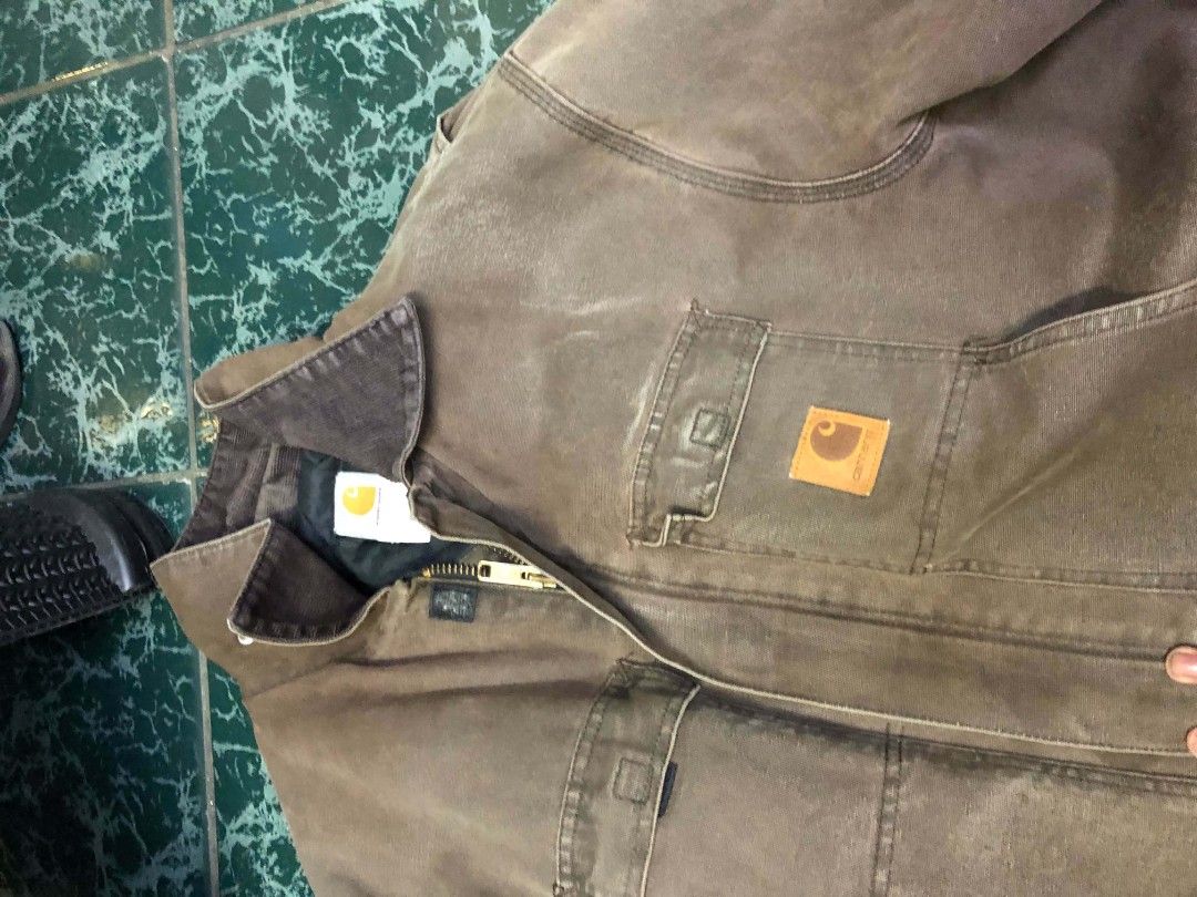 Carhartt Brown Canvas Work Jacket (Category: Coats, Jackets and Outerwear) located in Manila. Submitted by rheyrhey2323 (Listing ID 1460201052, Image 2). Description: - Classic Carhartt work jacket - Durable brown canvas material - Multiple front pockets - Zipper closure with snap button storm flap - Collar can be worn up or down - Ideal for work or casual wear.