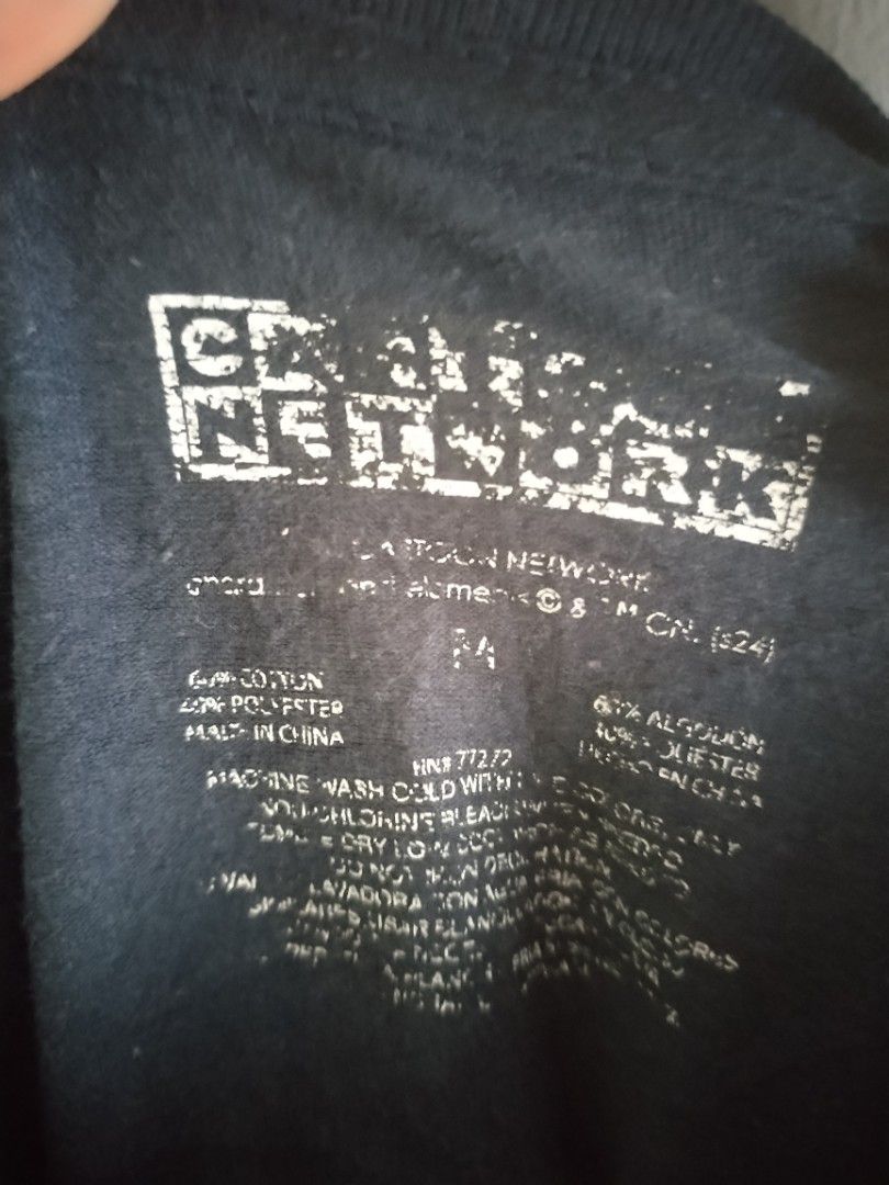 Cartoon Network T-Shirt - All Over Print (Category: Tshirts & Polo Shirts ) located in Naga. Submitted by basejohnpa64527 (Listing ID 1460122382, Image 2). Description: - Black t-shirt with fun Cartoon Network graphic print - Features characters from various classic shows - Made from a comfortable cotton-polyester blend - Size: Medium (M) - Ideal for fans of nostalgic cartoons.