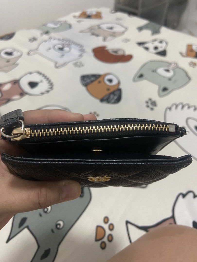 Chanel Black Caviar Quilted Zip Wallet (Category: Luxury Bags & Wallets) located in Quezon City. Submitted by emjen (Listing ID 1460140282, Image 2). Description: - Chanel wallet - Classic black caviar leather - Iconic quilted design - Signature gold CC logo - Secure zip closure - Small and compact size Authentic quality! - Ideal for cards and cash.