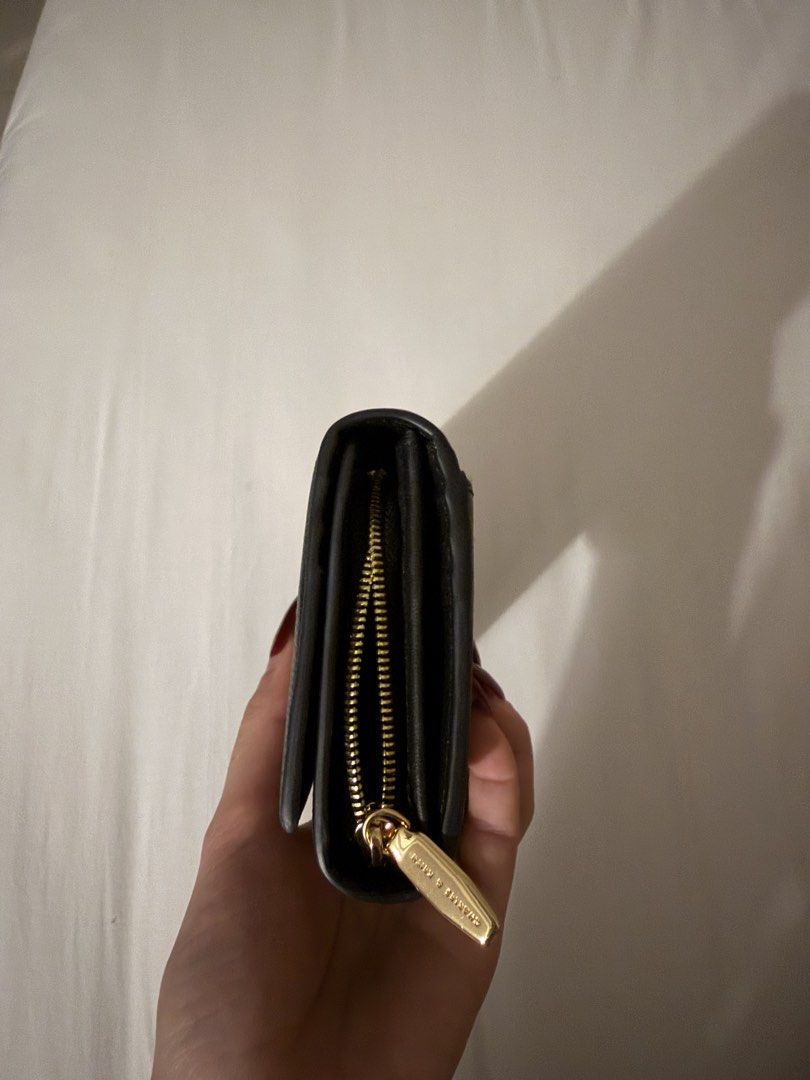 Charles & Keith Black Leather Long Wallet (Category: Wallets & Card holders) located in Makati City. Submitted by florencedoll (Listing ID 1460299309, Image 3). Description: - Genuine black leather long wallet from Charles & Keith - Secure zip closure - Multiple interior compartments for organization - Elegant gold hardware details - Ample space for cards and cash - Ideal for everyday use.