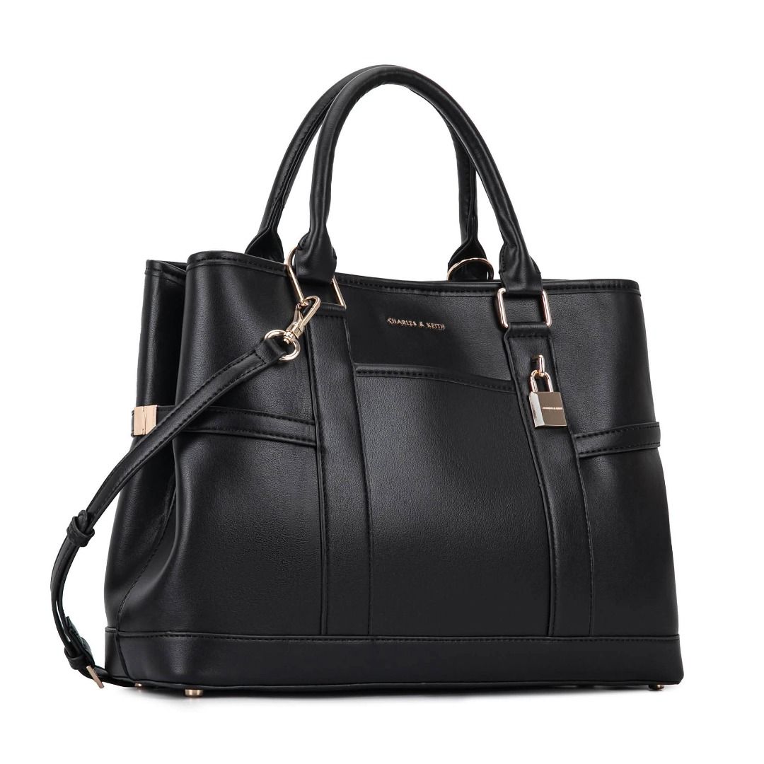 Charles & Keith Scottie Tote Bag (Category: Shoulder Bags) located in Quezon City. Submitted by makescentsmnl (Listing ID 1460255725, Image 3). Description: Charles & Keith Scottie Tote Bag ORIG MALL PULLOUT Size:36 cm With dust bag&serial number MOP ✅ GCASH ✅ BANK TRANSFER ✅ CREDIT CARD ✅ QRPH This Scottie tote bag in black features buckled side straps, a shiny gold-tone lock charm, a magnetic closure and a roomy interior. Let it elevate your ni
