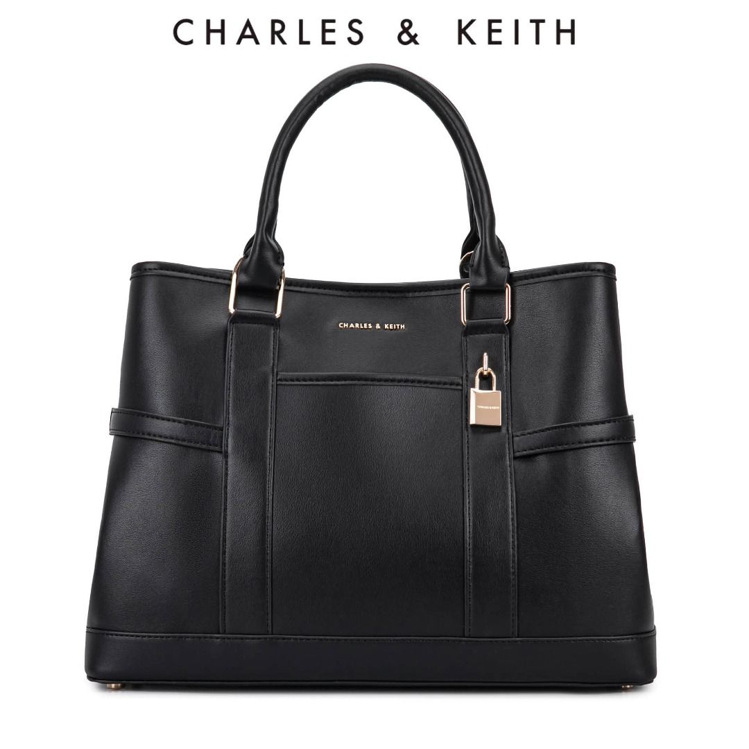 Charles & Keith Scottie Tote Bag (Category: Shoulder Bags) located in Quezon City. Submitted by makescentsmnl (Listing ID 1460255725, Image 1). Description: Charles & Keith Scottie Tote Bag ORIG MALL PULLOUT Size:36 cm With dust bag&serial number MOP ✅ GCASH ✅ BANK TRANSFER ✅ CREDIT CARD ✅ QRPH This Scottie tote bag in black features buckled side straps, a shiny gold-tone lock charm, a magnetic closure and a roomy interior. Let it elevate your ni