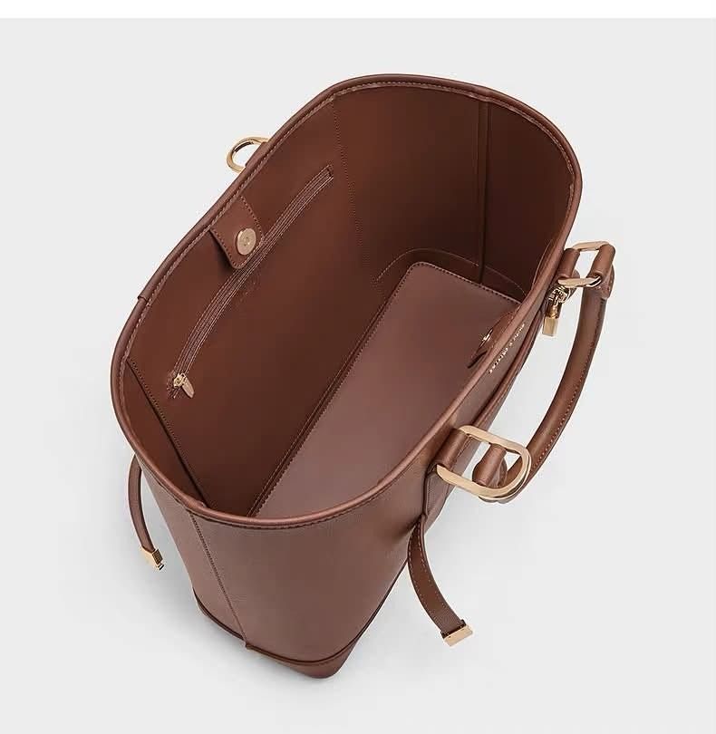 Charles & Keith Scottie Tote Bag (Category: Shoulder Bags) located in Quezon City. Submitted by makescentsmnl (Listing ID 1460255725, Image 2). Description: Charles & Keith Scottie Tote Bag ORIG MALL PULLOUT Size:36 cm With dust bag&serial number MOP ✅ GCASH ✅ BANK TRANSFER ✅ CREDIT CARD ✅ QRPH This Scottie tote bag in black features buckled side straps, a shiny gold-tone lock charm, a magnetic closure and a roomy interior. Let it elevate your ni